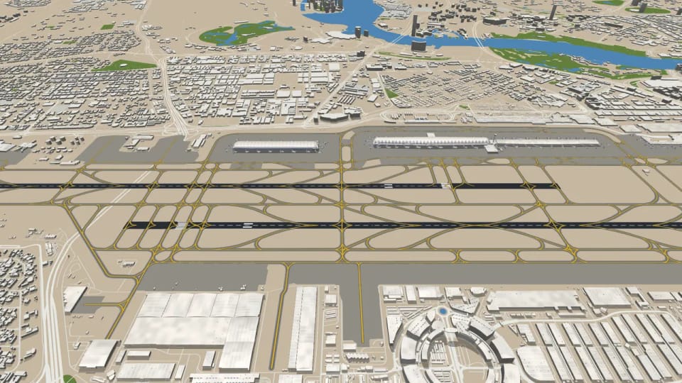 The same view of Dubai with sand-coloured ground between the runways and in the city, only the parks along the creek still green