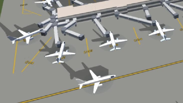 Ein näherer Blick auf Flugzeuge an den Fluggastbrücken, der Schatten jedes Seitenleitwerks zieht sich weit über den Beton