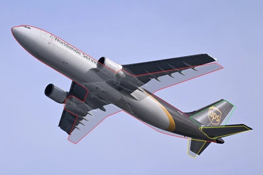 Photo of a UPS A300-600 climbing away with the outline of our former model over it, the wing and flaps not matching